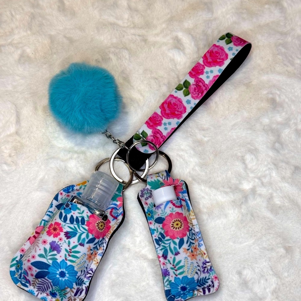 Combination keychain, chapstick, and hand sanitizer holder in blue floral